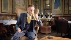 smartly dressed man drinking beer Orb Brand Viral Video by video production company Vermillion Films in Birmingham