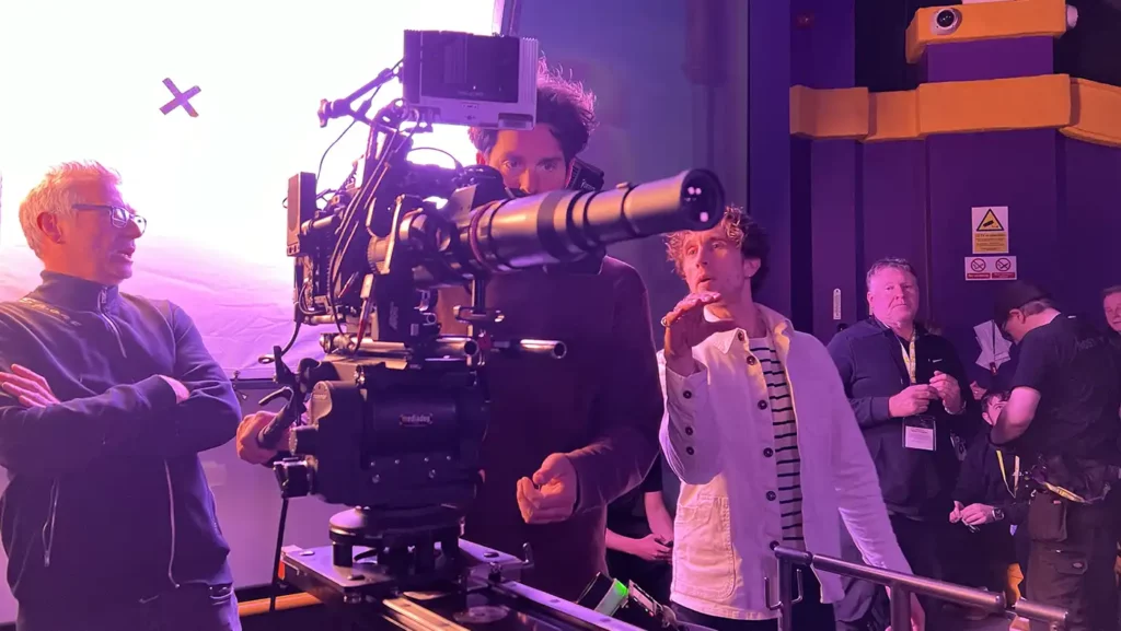 Video Production in progress, two men looking at a fancy cinema camera.