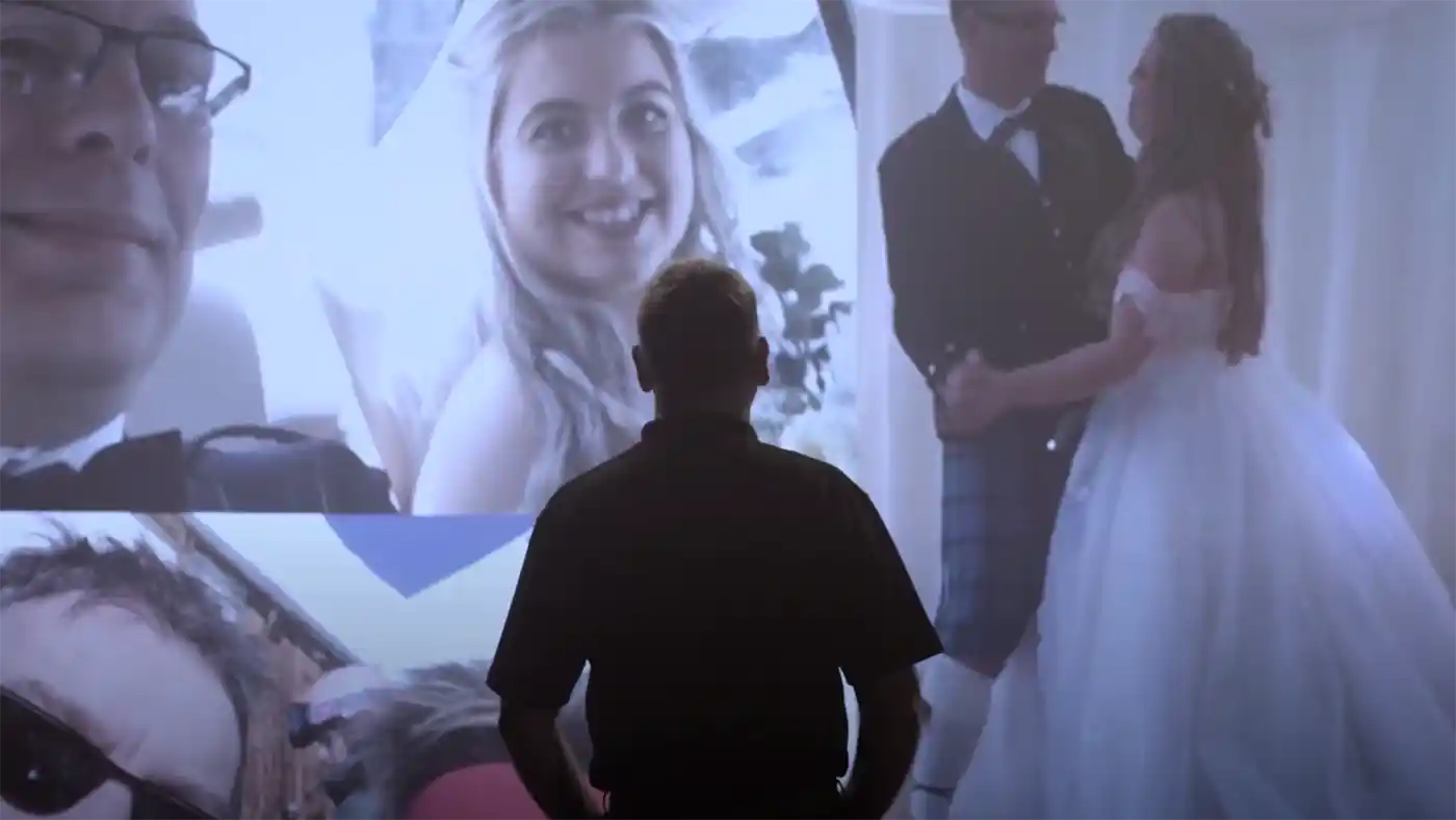 Video Production image of a man looking at a giant TV wall